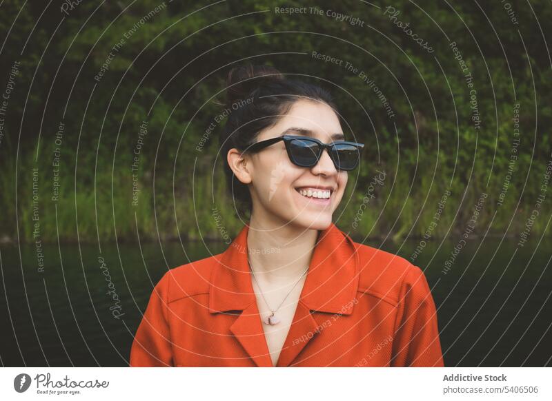 Smiling young woman in sunglasses near lake on vacation tourist montebello lakes lakeside summer cheerful tourism chiapas mexico red national park trendy