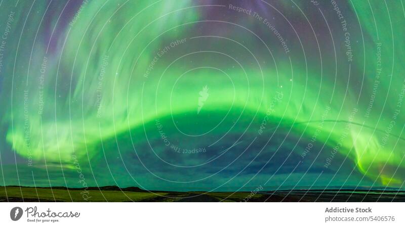 Aurora borealis over field aurora borealis polar light night effect phenomenon nature environment Iceland scenic polaris landscape scene natural northern