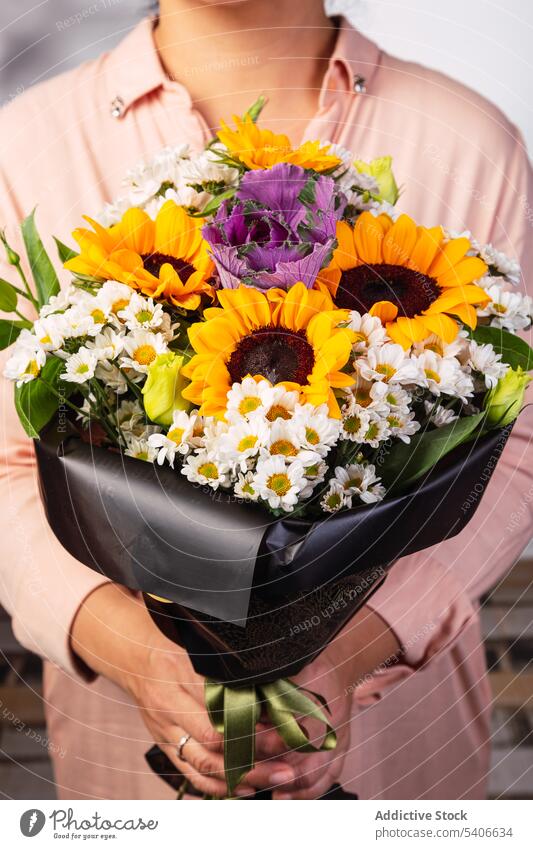 Crop woman with bouquet of flowers florist gift present bunch wrap aromatic flora bloom plant fresh floral style celebrate store floristry female lady botany