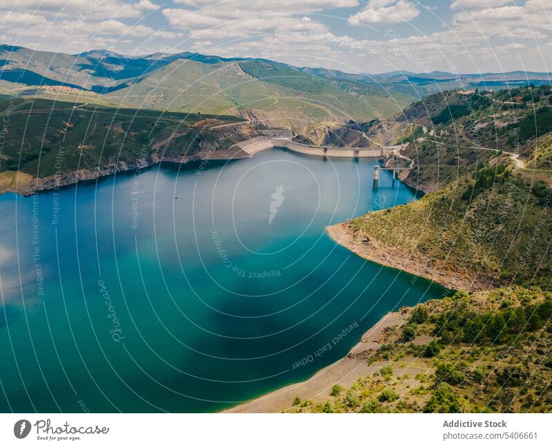 Scenic landscape of lake surrounded by mountains nature valley forest picturesque lakeside ridge calm breathtaking water tree scenery sunny idyllic serene