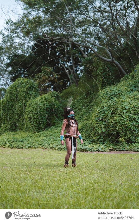 Indigenous mayan man standing against lush vegetation indigenous native aztec tribes historical history warrior mexico green rastafarian ulama warpaint dance