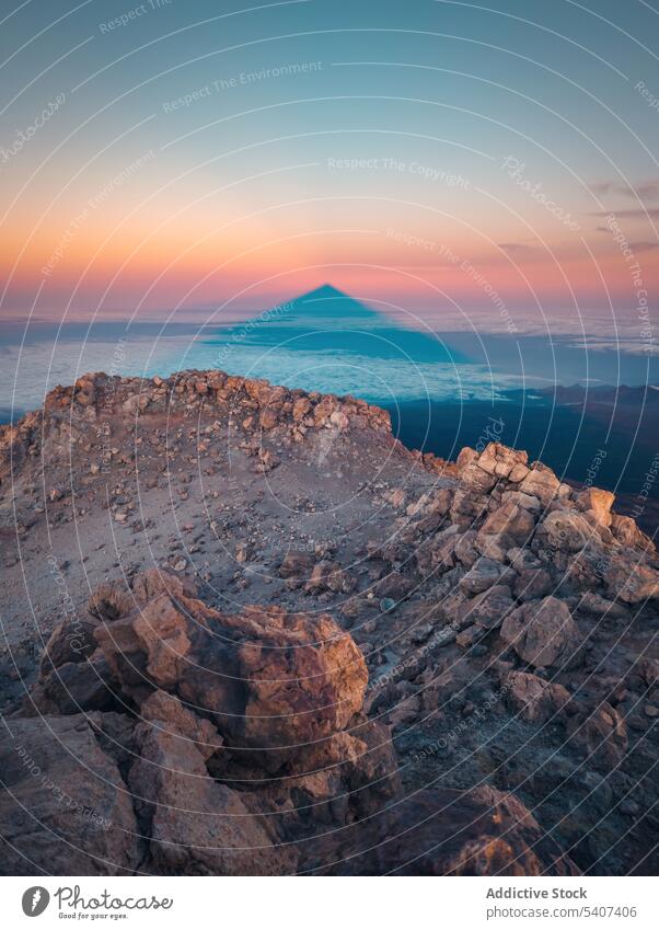 Amazing view of volcanic terrain with rocks and sunset cloudy sky in evening magnificent mountain volcano rocky rough orange blue sky highland environment