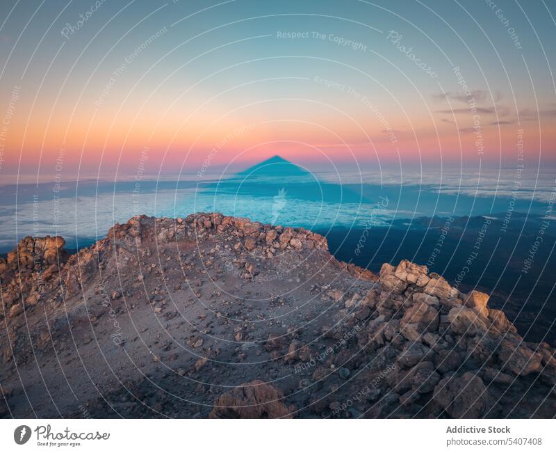 Amazing view of volcanic terrain with rocks and sunset cloudy sky in evening magnificent mountain volcano rocky rough orange blue sky highland environment