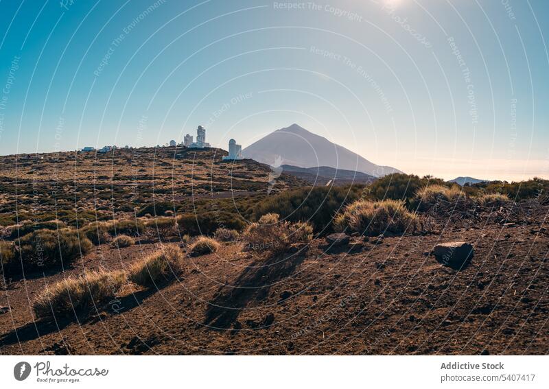 Dry bushes path leading to observatory on hill under blue sky picturesque mountain landscape nature environment dry sunlight terrain tourism panorama cloudless