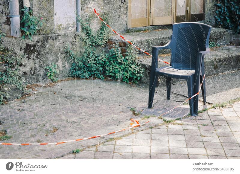 Lonely plastic chair, red and white barrier tape, deserted area, lost Plastic chair Chair stacking chair Band Doomed forsake sb./sth. Useless Futile Sit