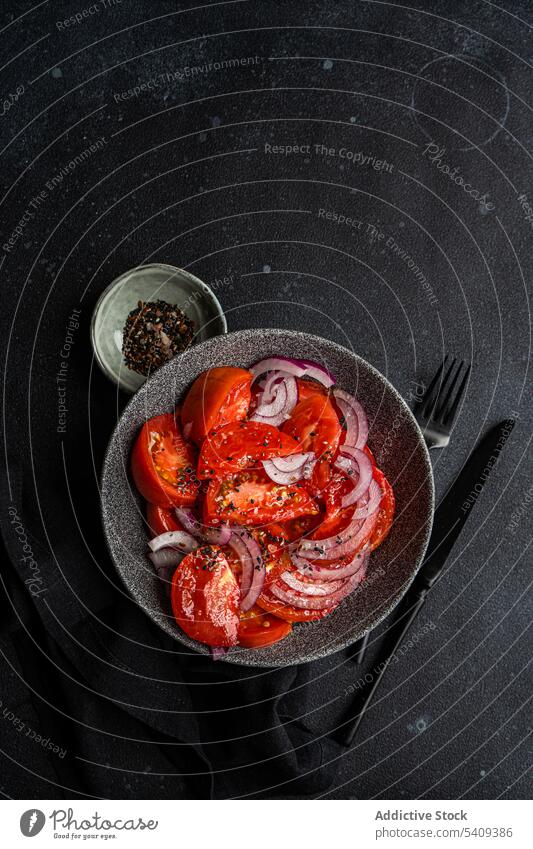 Bowl with salad tomatoes flax seeds vegan bowl healthy fabric wrinkled fresh raw onion ingredient sea salt organic natural food cutlery diet cloth tasty