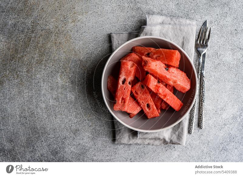 Watermelon in a bowl on concrete background watermelon fresh served fruit plate dessert summer garnish tablecloth piece food diet healthy detox breakfast vegan