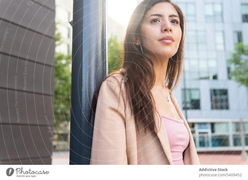 Dreamy businesswoman standing on street entrepreneur pensive thoughtful manager building downtown self assured leader Middle Eastern ethnic confident female