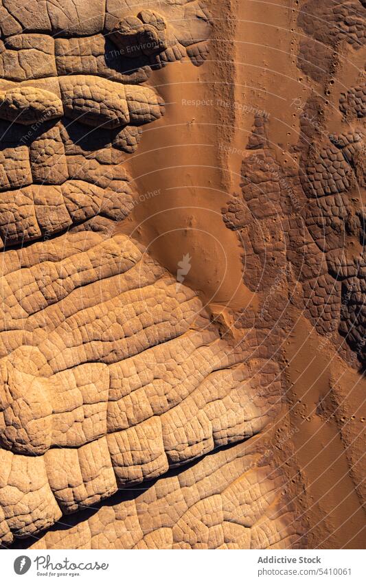 Rocky cliffs and sandy ground on sunny day in desert terrain canyon landscape formation nature rocky mountain scenery valley picturesque breathtaking amazing