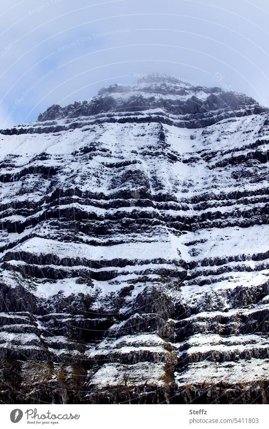 snow covered steep rocky hill on a Faroe island färöer Faroe Islands Rock mound Sheep Islands rock island snow-covered Steep rocky shore Steep face steep coast