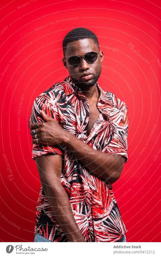 Stylish black man in sunglasses tropical shirt trendy fashion confident outfit appearance portrait style model male african american serious individuality