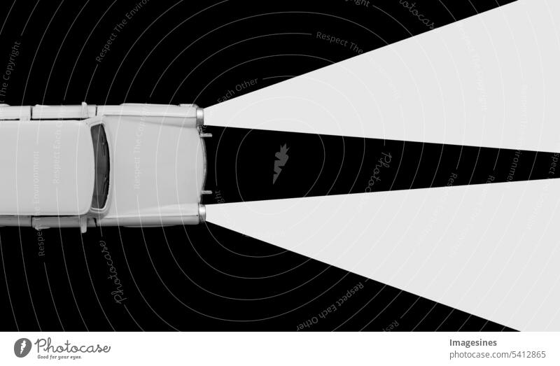 Retro car toy model and xenon lamps headlights concept. Black and white background. Rent a car, travel accident, insurance purchase, minimal concept. Abstract