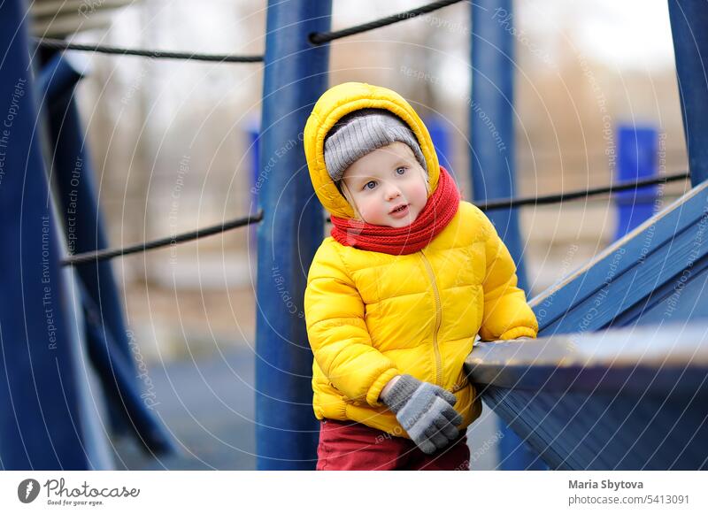 Cute little boy having fun on outdoor playground wooden climb kid ship winter day cold playtime equipment casual child kindergarten cute outdoors leisure