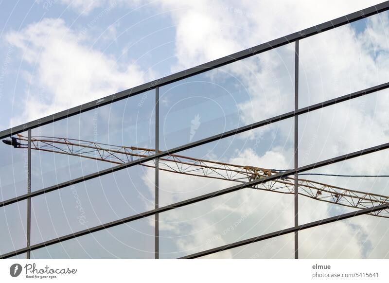 Crane boom and clouds reflected in a glass facade crane boom reflection Glas facade Clouds Reflection Architecture Construction site Blog Facade