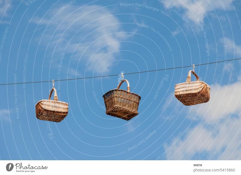 Wicker baskets stretched on ropes in front of blue sky as decoration in the basket weaving town of Lichtenfels in Upper Franconia on the Main River Germany