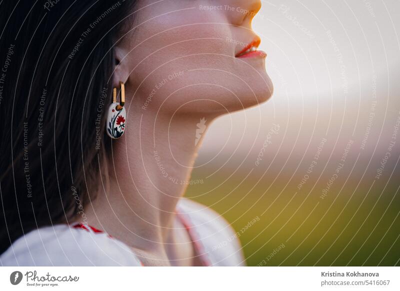 Young woman with ethnic earring and shirt with traditional ornaments breath free attractive beads beautiful beauty blossom cloth embroidered cloth texture