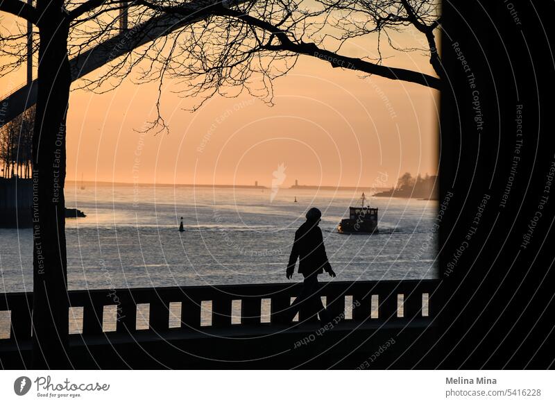 Man walking along the beach front in Porto Silhouette sunset sky Sky Evening Twilight Sunlight Ocean golden hour Nature nostalgic Shadow boat View from a window