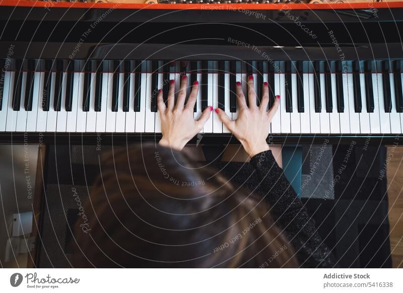 Top view of cropped hands playing the piano top view woman musician elegant room pianist instrument keyboard art sound performance melody classical harmony