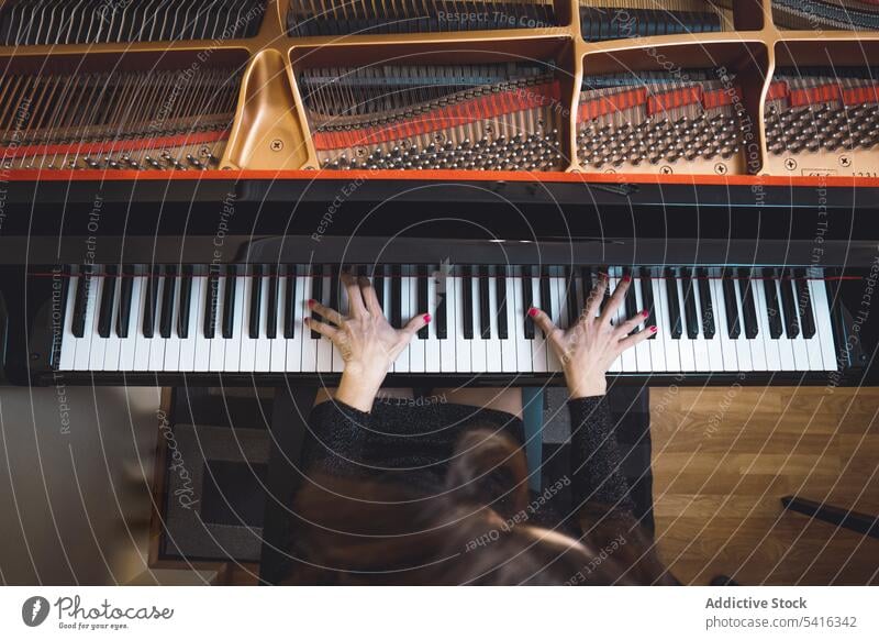 Top view of cropped hands playing the piano top view woman musician elegant room pianist instrument keyboard art sound performance melody classical harmony