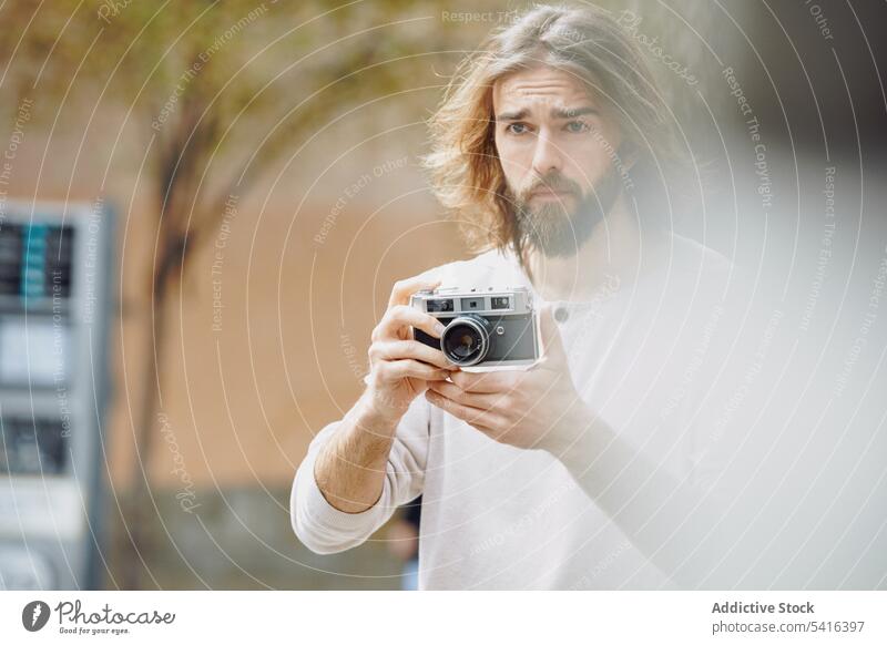 Handsome man setting up camera in hand handsome taking photo black pensive photographer mustache stubble adult hat lifestyle photographing bearded model network