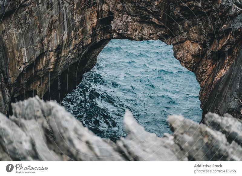 Picturesque rocks and sea cliff arch cave landscape natural passage water hole picturesque peaceful breathtaking tranquil calm idyllic scenic high beautiful