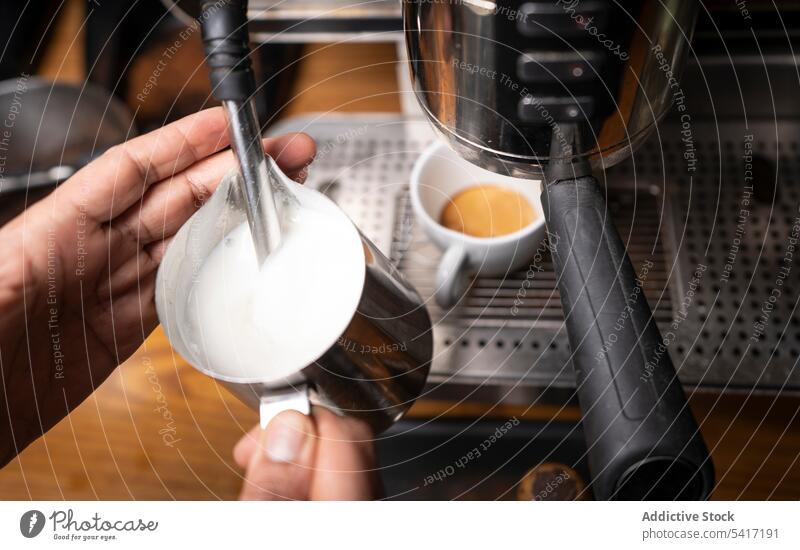 Barista making coffee with latte art barista cappuccino cup hand foam beverage pattern cafe occupation adult person professional pouring decorating hot milk