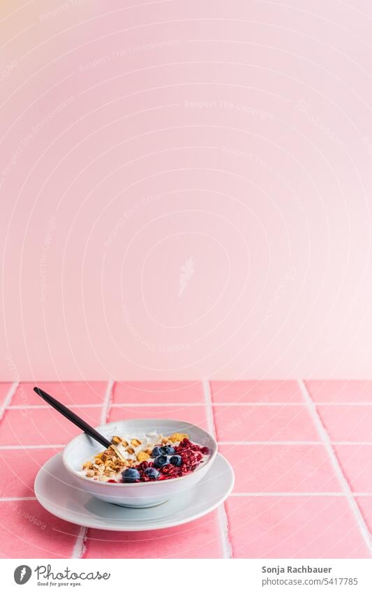 A bowl of yogurt, cereal and fresh berries on pink tiles. Healthy breakfast. Breakfast Cereal Yoghurt Berries Pink Food cute Morning Modern Minimalistic