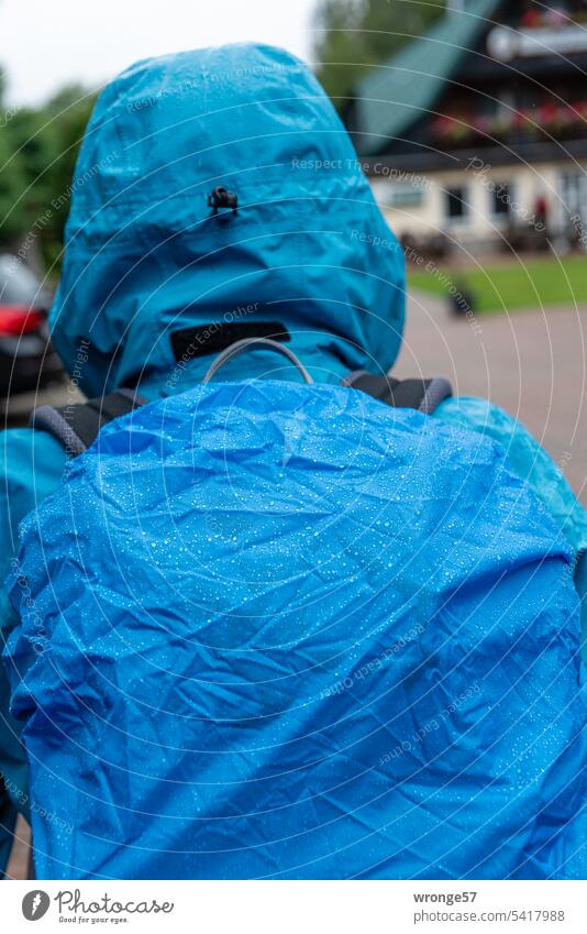 Hike in the rain hike Rain raindrops rain shelter Rainwear Rain cover Backpack Wet Weather Drops of water Bad weather Rainy weather Close-up Blue person Damp