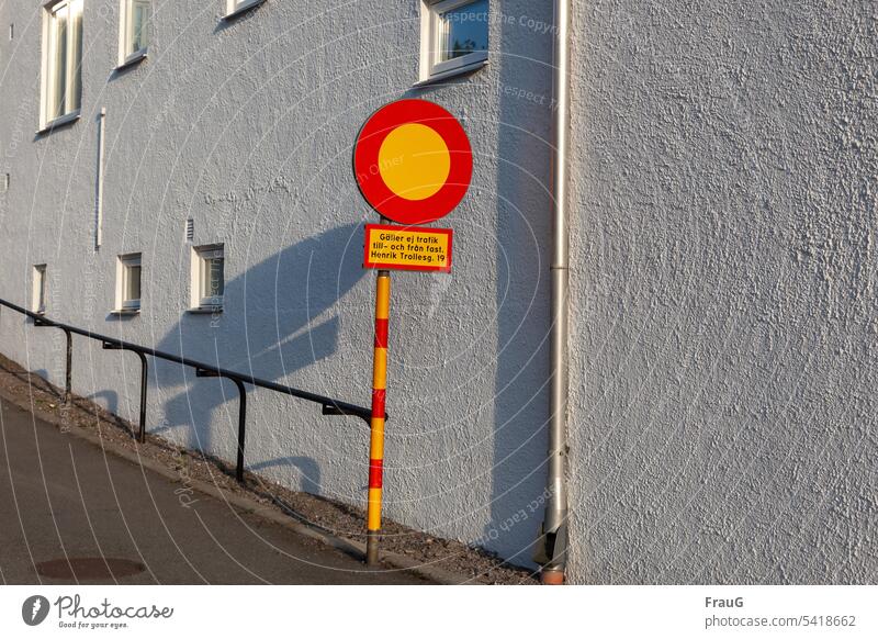 Traffic sign in Sweden house wall Facade Window Downspout Street handrail uphill Prohibition sign Road sign interdiction Ban on all types of vehicles