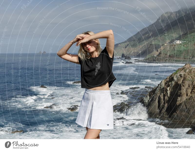 It’s a bit cloudy and moody day in Anaga, Tenerife. This majestic coastline is accompanied by a gorgeous blonde girl who is definitely on vacation. No cloudy sky can ruin her day. A pretty girl in a picturesque place.