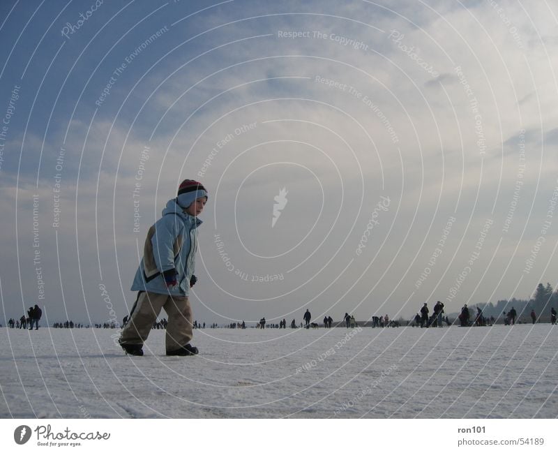 TIMON Child Lake Frozen Clouds Human being Baseball cap Cap Jacket Pants Winter Cold White Boy (child) Ice Snow Sky Frozen surface Blue