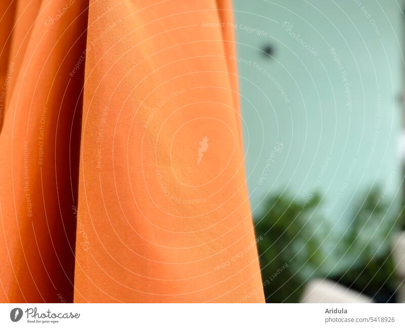 Orange parasol in front of mint green wall Sunshade Exterior shot Terrace Cloth textile Detail Material blurriness Contrast Folds Wrinkles Structures and shapes