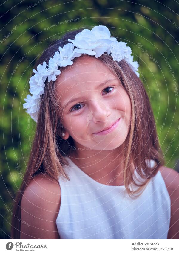 Small cute girl in elegant dress and flower headband child beauty little adorable kid innocence pensive female purity individuality comely sweet hair positive