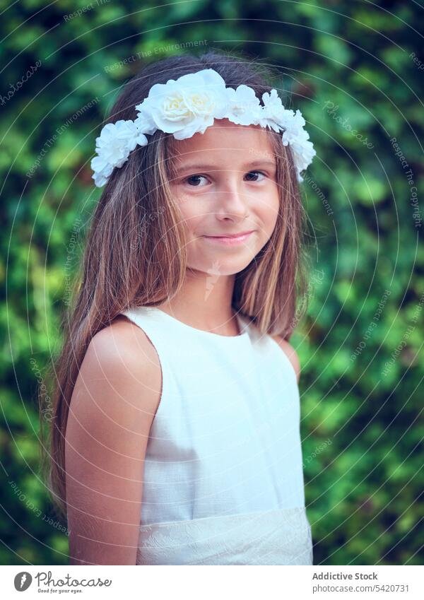 Small cute girl in elegant dress and flower headband child beauty little adorable kid innocence pensive female purity individuality comely sweet hair positive