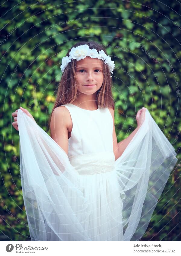 Small cute girl in elegant dress and flower headband child beauty little adorable kid innocence pensive female purity individuality comely sweet hair positive