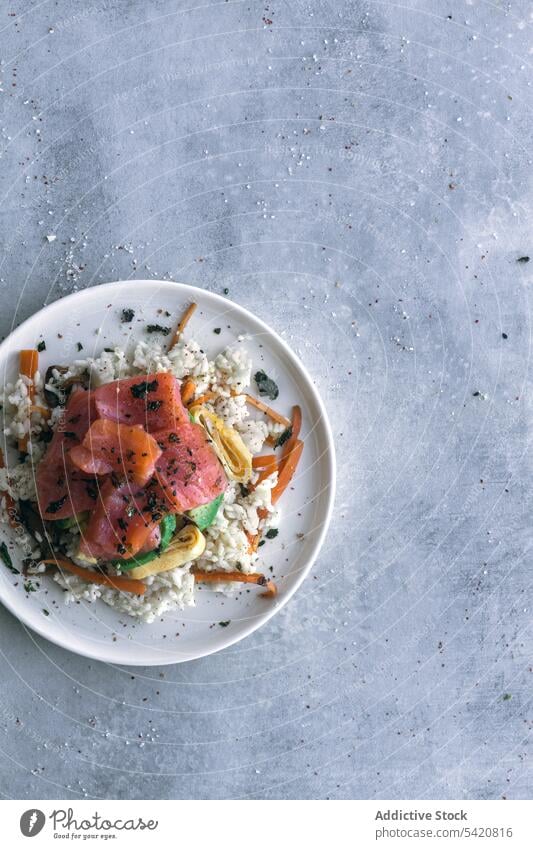 Tasty crumbly rice with salmon and vegetables on linen on table dish asian food meal poke fresh healthy fish appetizer tasty cuisine culinary gourmet raw snack