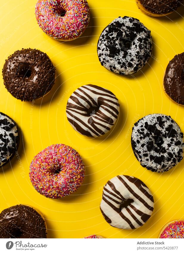 Variety of doughnuts on pink background variety assortment sweet icing glazed food donut sugar bakery pastry sprinkle fried colorful many dessert delicious