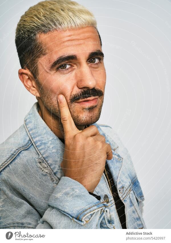 Stylish grimacing man in denim outfit trendy independent expressive grimace style modern hipster ethnic male jacket mustache confident fashion contemporary