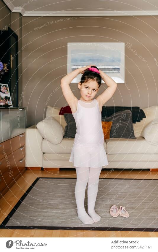 Little girl preparing for ballet rehearsal at home ballerina prepare hair bun leotard living room little dancer cozy child kid workout lesson practice gymnastic