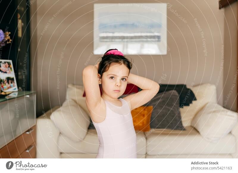 Little girl preparing for ballet rehearsal at home ballerina prepare hair bun leotard living room little dancer cozy child kid workout lesson practice gymnastic