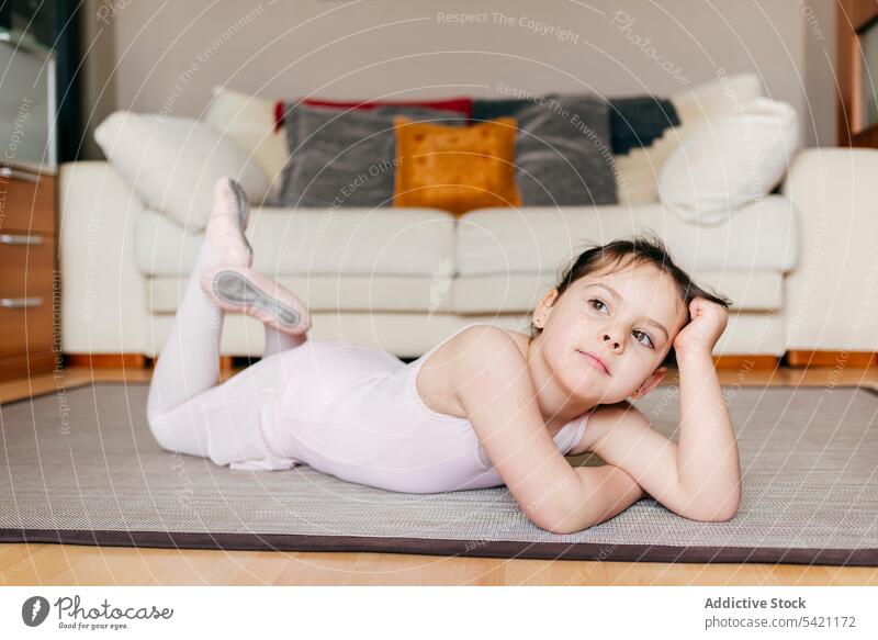 Bored little ballerina lying on the floor girl bored rehearsal break home living room ballet child kid leotard disinterested tired exhausted relax training