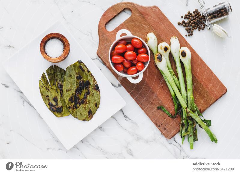 Grilled ingredients and seasonings for salad vegetable grill healthy vegetarian cook spice cherry bowl tomato kitchen board onion green pepper plate dinner herb