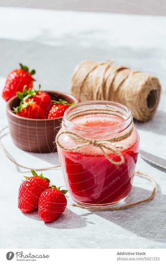 Healthy strawberry drink in glass jar juice homemade rustic fresh natural healthy twine knife tasty ripe delicious food vitamin ingredient nutrition appetizing