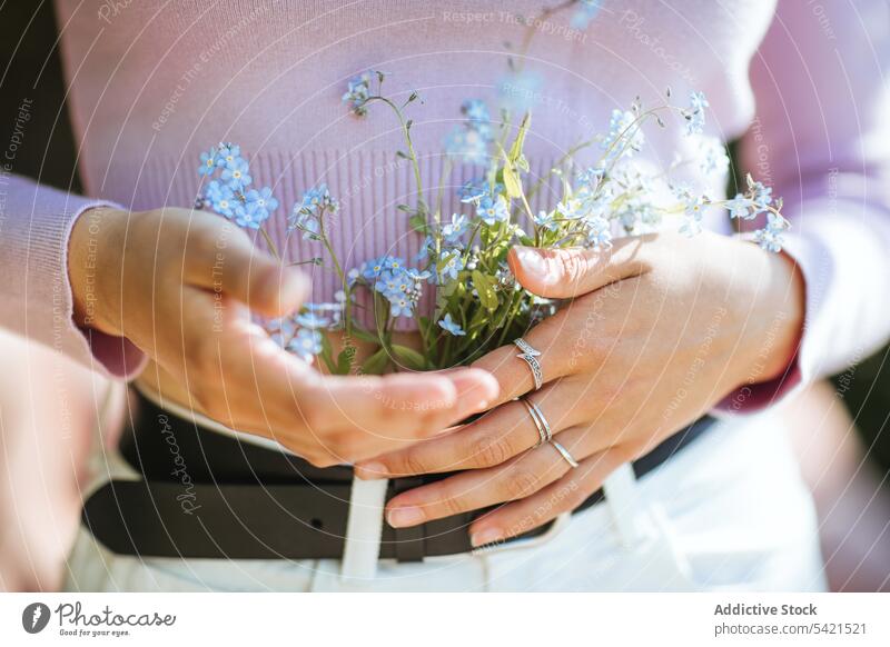 Anonymous tender girl with flowers in jeans teenage wildflower summer garden delicate serene bloom plant flora harmony summertime tranquil blossom carefree calm