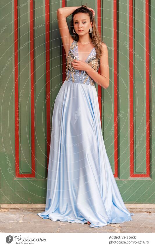 Elegant young woman in maxi dress style elegant fashion gown romantic occasion glamour female model blue slim outfit gorgeous charming appearance cloth feminine