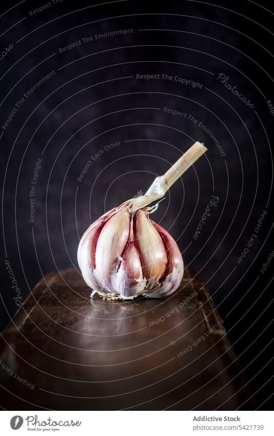 Garlic placed on wooden table garlic head whole rustic kitchen natural organic fresh healthy food plant ingredient ripe shabby vegan gourmet vegetarian vitamin