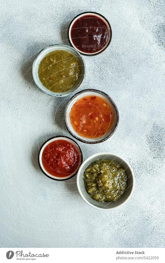 Bowls with traditional Georgian sauces: green plum Tkemali sauce, tomato and cilantro Satsebeli sauce, Kiwi satsebeli bowl ceramic georgian kiwi dish ingredient