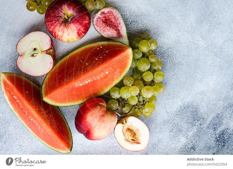 Seasonal fruit frame on white surface seasonal high angle from above watermelon grape apple cut fresh food organic colorful design decoration set healthy