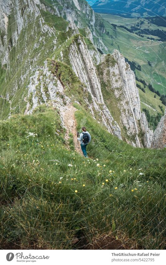 Woman hiking on path in swiss mountains Vantage point Panorama (View) Mountain Sky Clouds Alpstein hiking country appenzellerland Appenzell Grass stones Rock