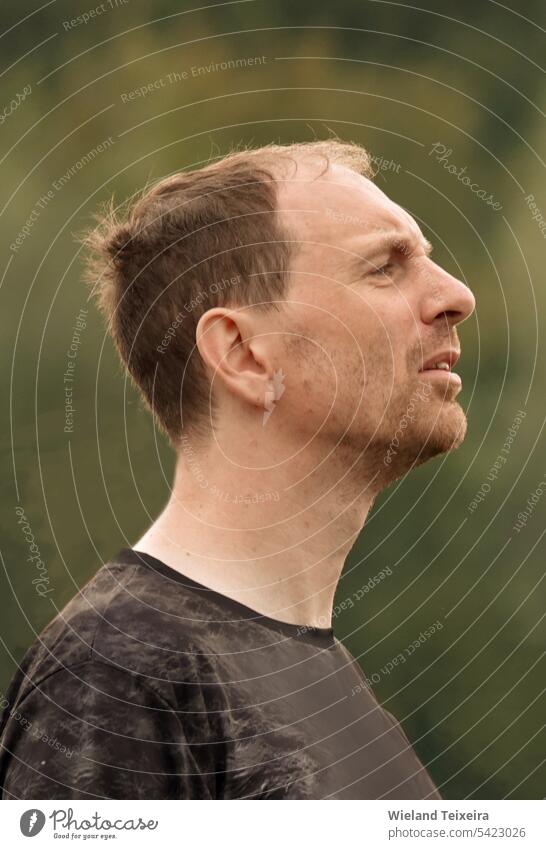 Portrait of a man listening intently to someone explaining in front of a crowd Face Person green nature beautiful outdoor hair closeup park people outdoors male